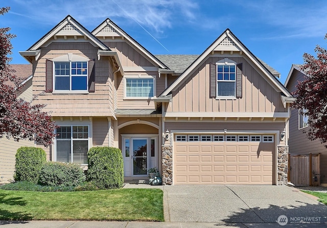 27006 229th Pl SE, Maple Valley, WA 98038 - view of front of home with board and batten siding, concrete driveway, a front yard, and stone siding