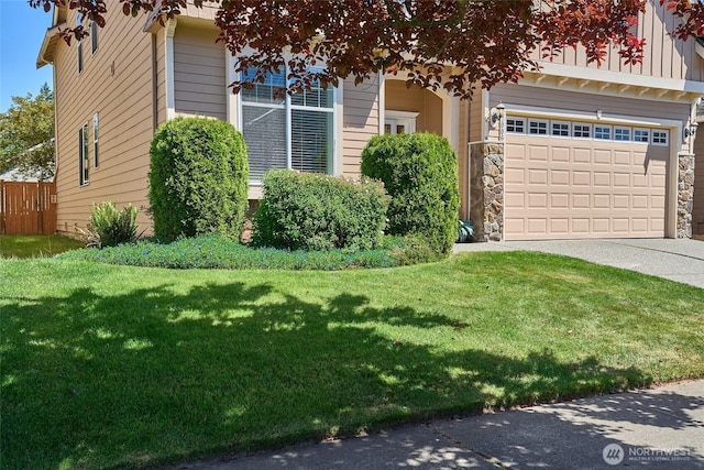 27006 229th Pl SE, Maple Valley, WA 98038 - obstructed view of property featuring concrete driveway, a front yard, stone siding, and a garage
