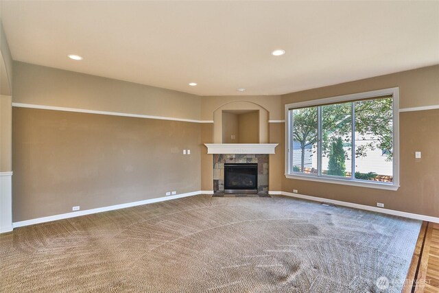 27006 229th Pl SE, Maple Valley, WA 98038 - unfurnished living room with a stone fireplace, baseboards, and recessed lighting