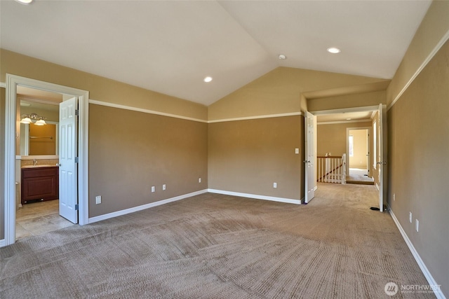 27006 229th Pl SE, Maple Valley, WA 98038 - unfurnished bedroom with lofted ceiling, light carpet, baseboards, a sink, and connected bathroom