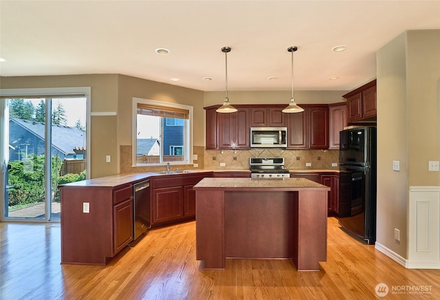 27006 229th Pl SE, Maple Valley, WA 98038 - kitchen with stainless steel appliances, light countertops, light wood-type flooring, decorative backsplash, and recessed lighting