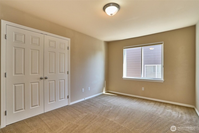 27006 229th Pl SE, Maple Valley, WA 98038 - unfurnished bedroom featuring carpet floors, a closet, and baseboards