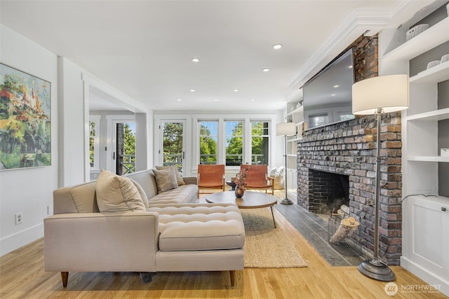 1542 Grand Ave, Seattle, WA 98122 - living room featuring a brick fireplace, wood finished floors, recessed lighting, and baseboards