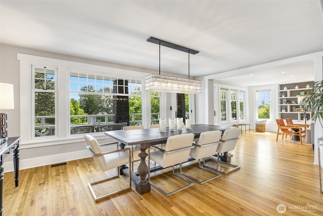 1542 Grand Ave, Seattle, WA 98122 - dining room with healthy amount of natural light, light wood finished floors, and baseboards