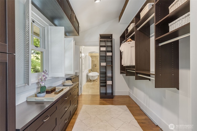 1542 Grand Ave, Seattle, WA 98122 - walk in closet with wood finished floors, lofted ceiling, and arched walkways