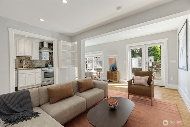 1542 Grand Ave, Seattle, WA 98122 - living room with light wood-style flooring, recessed lighting, baseboards, and french doors