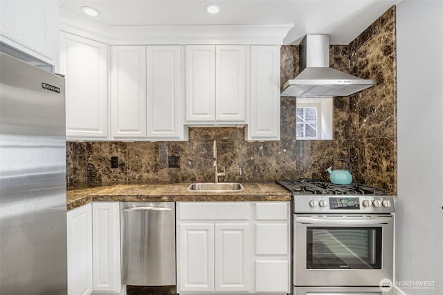 1542 Grand Ave, Seattle, WA 98122 - kitchen featuring appliances with stainless steel finishes, wall chimney range hood, a sink, and white cabinets