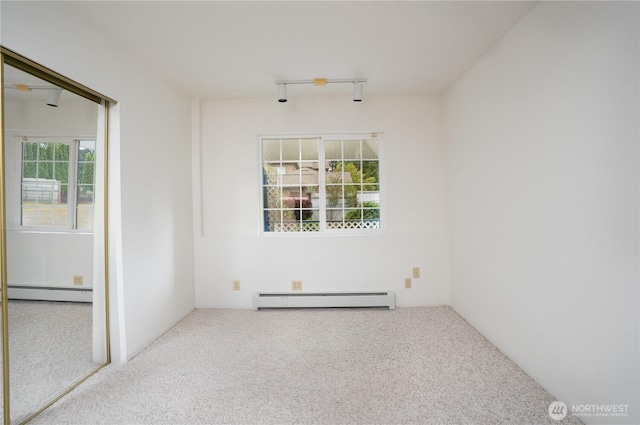 818 295th St E, Roy, WA 98580 - carpeted empty room with a baseboard radiator