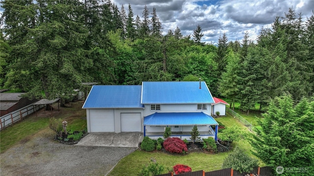 818 295th St E, Roy, WA 98580 - view of front of house featuring metal roof, asphalt driveway, a wooded view, and a garage