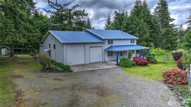 818 295th St E, Roy, WA 98580 - view of front of home featuring a garage, covered porch, driveway, and metal roof