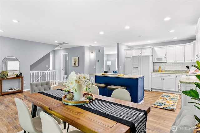 17655 Division Ave NE, Suquamish, WA 98392 - dining space with light wood finished floors, recessed lighting, baseboards, and stairs