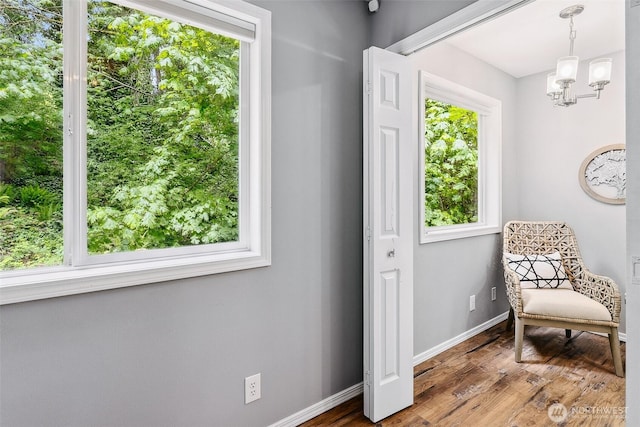 17655 Division Ave NE, Suquamish, WA 98392 - sitting room with plenty of natural light, a chandelier, baseboards, and wood finished floors