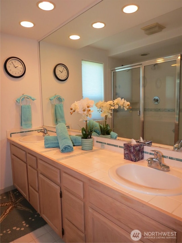 1599 E Ocean Shores Blvd SW Unit 2E, Ocean Shores, WA 98569 - bathroom with double vanity, a shower stall, recessed lighting, and tile patterned flooring