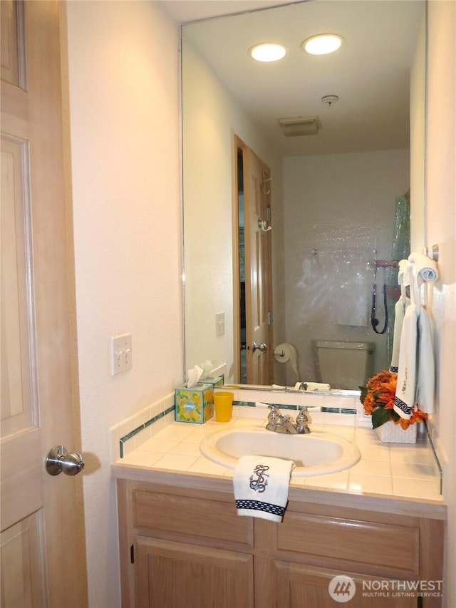 1599 E Ocean Shores Blvd SW Unit 2E, Ocean Shores, WA 98569 - bathroom with vanity, toilet, and recessed lighting