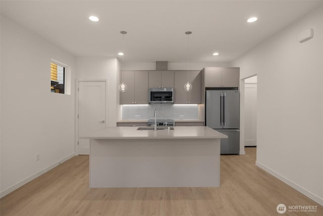 9223A 14th Ave NW, Seattle, WA 98117 - kitchen featuring appliances with stainless steel finishes, gray cabinets, baseboards, light wood-style flooring, and recessed lighting
