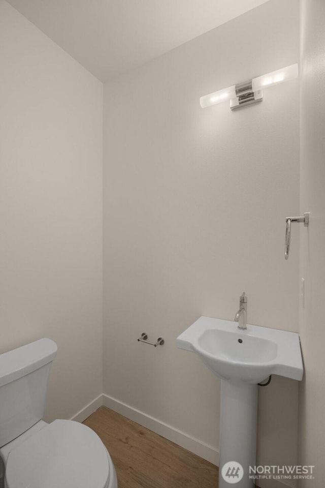 9223A 14th Ave NW, Seattle, WA 98117 - half bathroom with toilet, wood finished floors, and baseboards