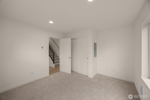 9223A 14th Ave NW, Seattle, WA 98117 - unfurnished bedroom featuring carpet, recessed lighting, a closet, baseboards, and electric panel