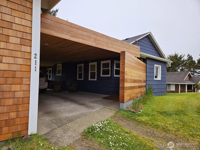 211 NW 25th St, Long Beach, WA 98631 - view of home's exterior with a carport and a lawn