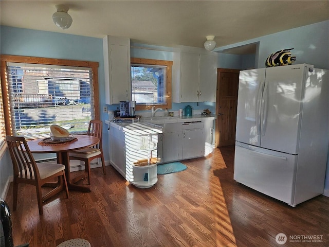 211 NW 25th St, Long Beach, WA 98631 - kitchen featuring freestanding refrigerator, a sink, wood finished floors, white cabinets, and light countertops