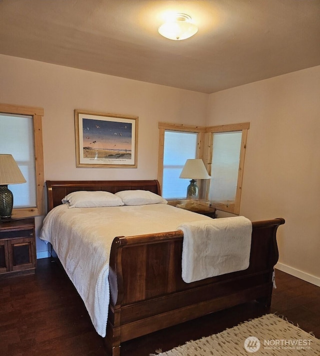 211 NW 25th St, Long Beach, WA 98631 - bedroom with wood finished floors, baseboards, and multiple windows