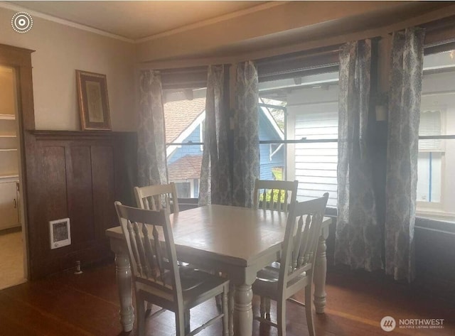 720 N L St, Tacoma, WA 98403 - dining space featuring ornamental molding, healthy amount of natural light, wood finished floors, and heating unit