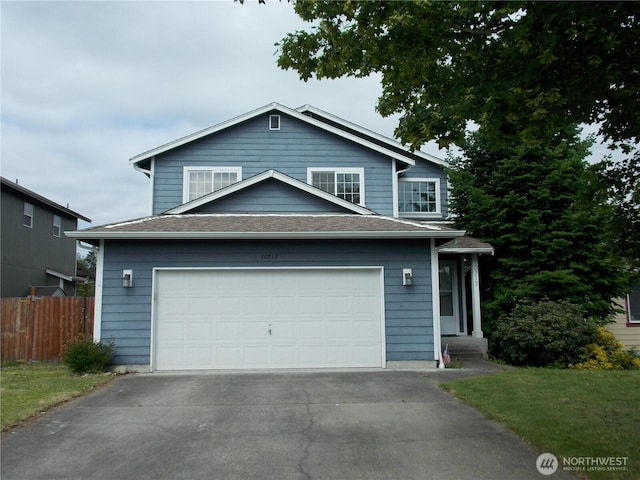 10717 Umtanum St SE, Yelm, WA 98597 - view of front of property with asphalt driveway, a garage, and roof with shingles
