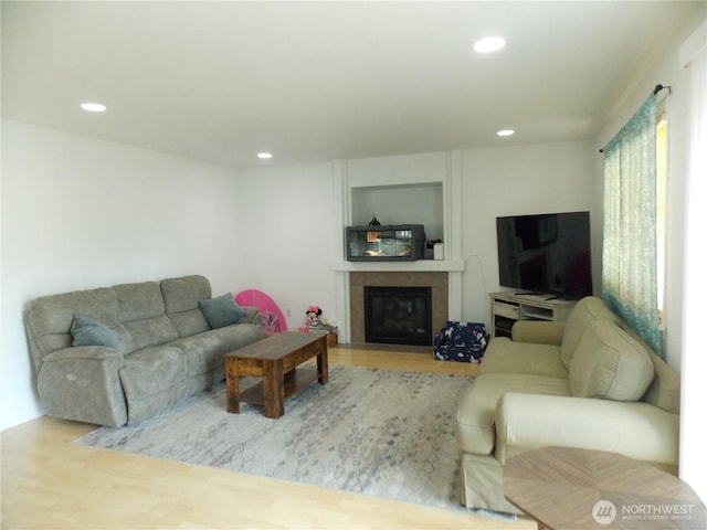 10717 Umtanum St SE, Yelm, WA 98597 - living area featuring wood finished floors, recessed lighting, and a glass covered fireplace