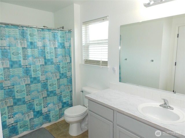 10717 Umtanum St SE, Yelm, WA 98597 - bathroom with vanity, toilet, a shower with shower curtain, and tile patterned flooring