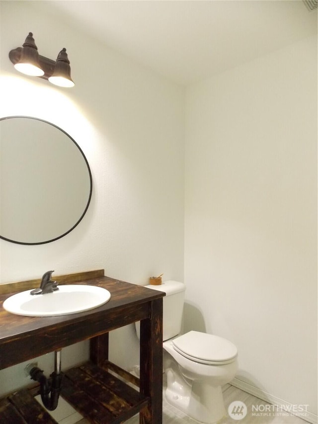 10717 Umtanum St SE, Yelm, WA 98597 - half bath with a sink, tile patterned floors, and toilet