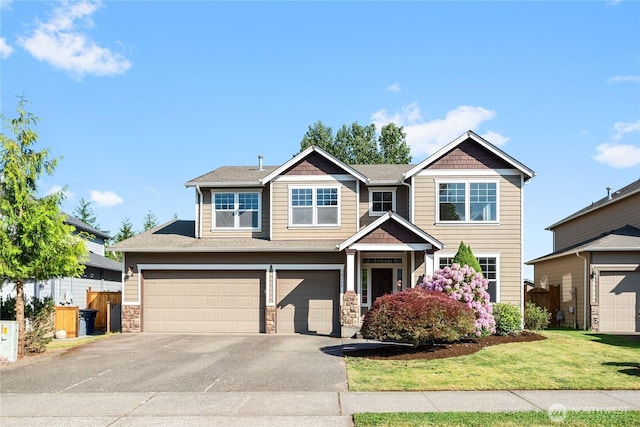 19333 205th St E, Orting, WA 98360 - craftsman inspired home featuring asphalt driveway, a garage, stone siding, and roof with shingles