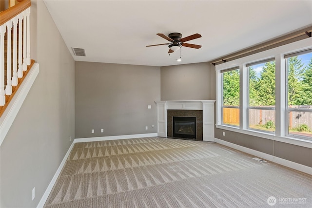 19333 205th St E, Orting, WA 98360 - unfurnished living room featuring baseboards, ceiling fan, carpet, and stairs