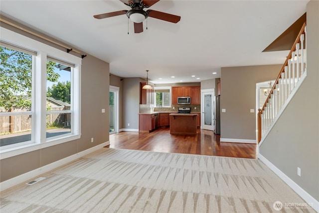 19333 205th St E, Orting, WA 98360 - unfurnished living room with stairway, baseboards, ceiling fan, and recessed lighting