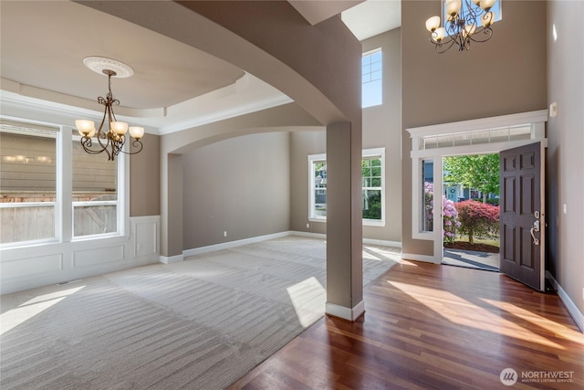 19333 205th St E, Orting, WA 98360 - foyer with a chandelier, arched walkways, wood finished floors, and baseboards