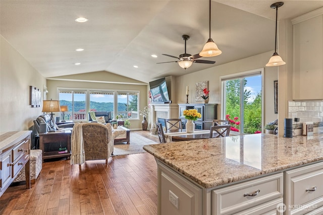 8 Clearview Dr, Longview, WA 98632 - kitchen with open floor plan, healthy amount of natural light, vaulted ceiling, dark wood-style flooring, and white cabinetry