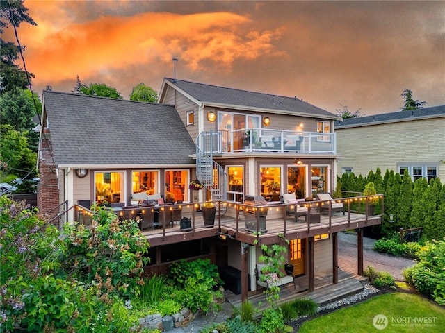 714 13th St, Bellingham, WA 98225 - back of house at dusk with a balcony, a wooden deck, and stairway