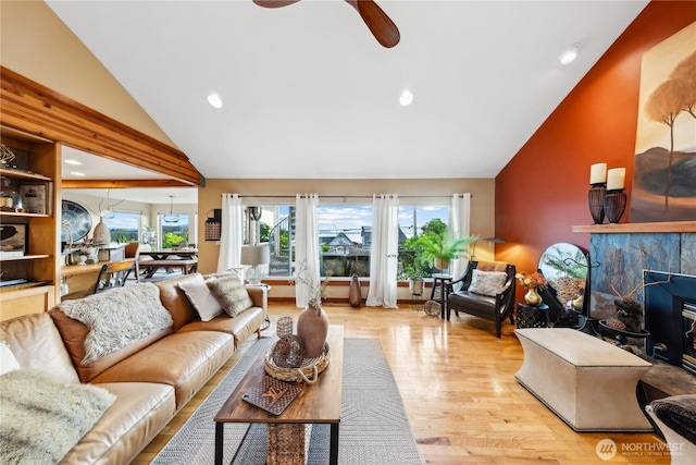714 13th St, Bellingham, WA 98225 - living area featuring vaulted ceiling, wood finished floors, a ceiling fan, recessed lighting, and a fireplace