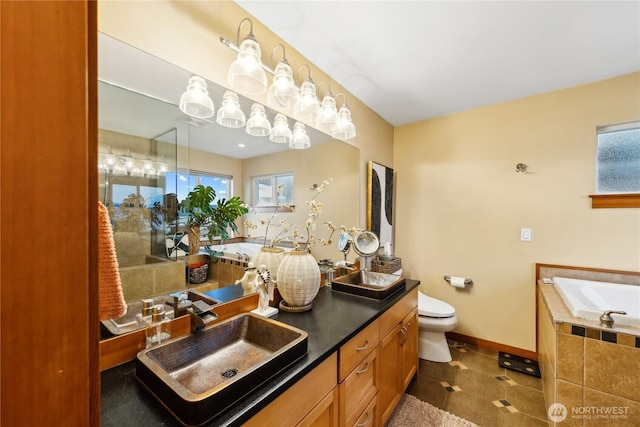 714 13th St, Bellingham, WA 98225 - full bath featuring a bath, double vanity, baseboards, and toilet
