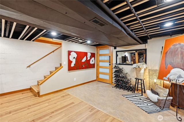 714 13th St, Bellingham, WA 98225 - finished below grade area with baseboards, wood finished floors, and stairs