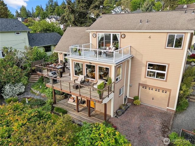 714 13th St, Bellingham, WA 98225 - back of house with a garage, a balcony, a wooden deck, and driveway
