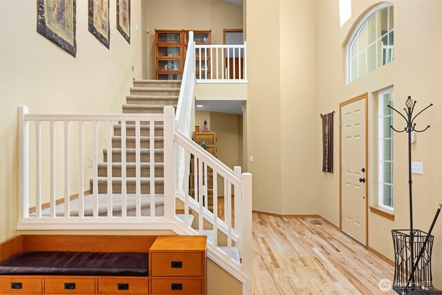 2041 NW Tregaten Ln, Poulsbo, WA 98370 - foyer entrance featuring stairway, a towering ceiling, and wood finished floors