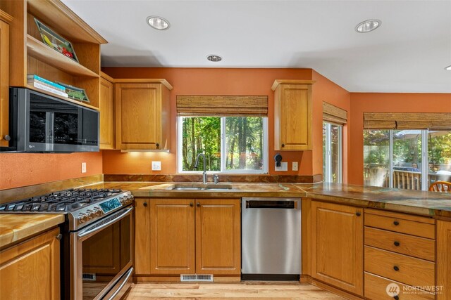 2041 NW Tregaten Ln, Poulsbo, WA 98370 - kitchen featuring stainless steel appliances, a sink, recessed lighting, light wood finished floors, and open shelves
