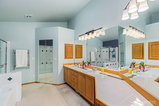 2041 NW Tregaten Ln, Poulsbo, WA 98370 - bathroom with double vanity, a shower stall, a bath, and baseboards