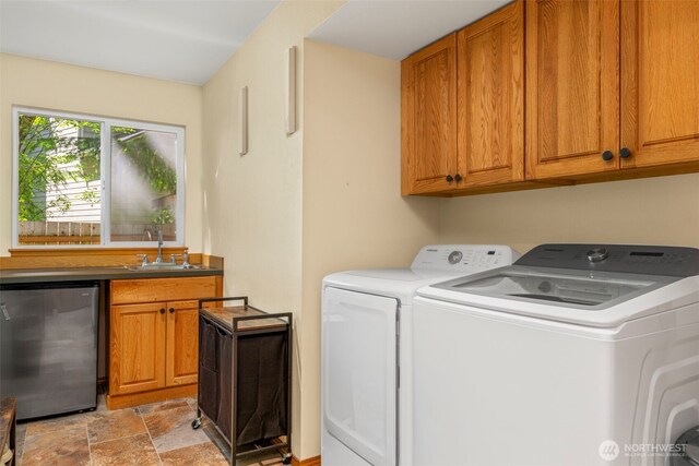 2041 NW Tregaten Ln, Poulsbo, WA 98370 - laundry room with washing machine and dryer, stone finish floors, and wet bar
