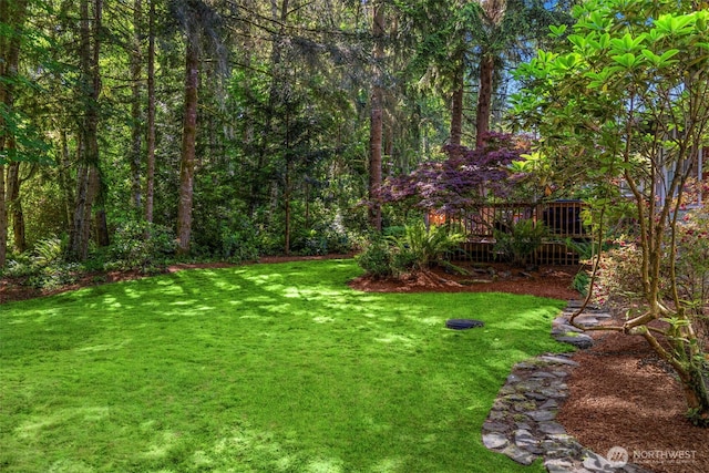 2041 NW Tregaten Ln, Poulsbo, WA 98370 - view of grassy yard featuring a wooden deck and a view of trees