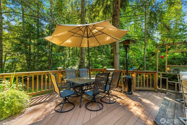 2041 NW Tregaten Ln, Poulsbo, WA 98370 - wooden terrace with outdoor dining space and view of scattered trees