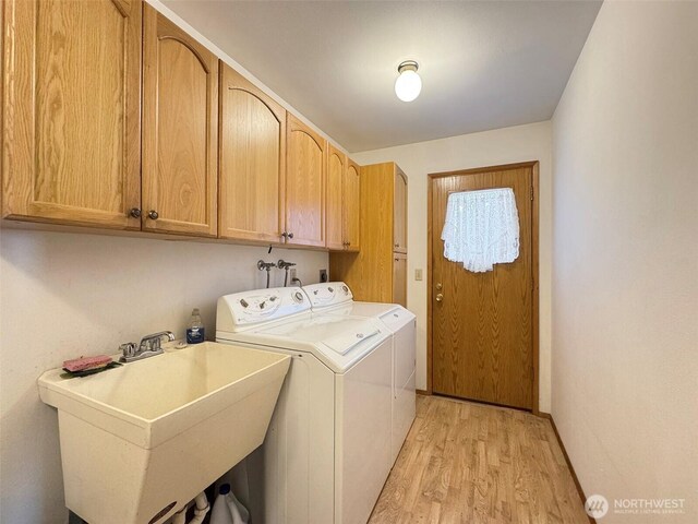 1813 E 3rd St, Port Angeles, WA 98362 - laundry area with washing machine and clothes dryer, cabinet space, light wood-style flooring, and baseboards