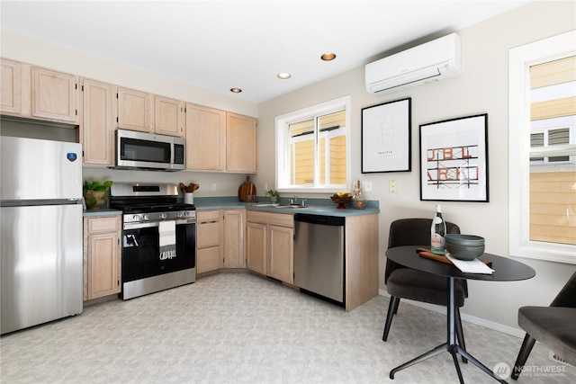 6537 5th Ave NE Unit B, Seattle, WA 98115 - kitchen with stainless steel appliances, light brown cabinets, an AC wall unit, dark countertops, and recessed lighting