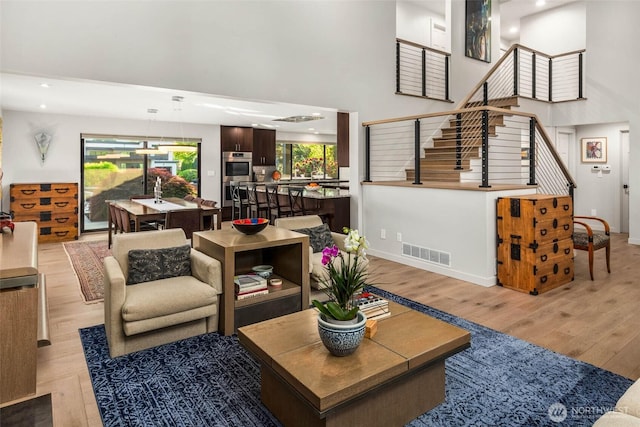 12 Columbia Ky, Bellevue, WA 98006 - living area with light wood-type flooring, stairway, a high ceiling, baseboards, and recessed lighting