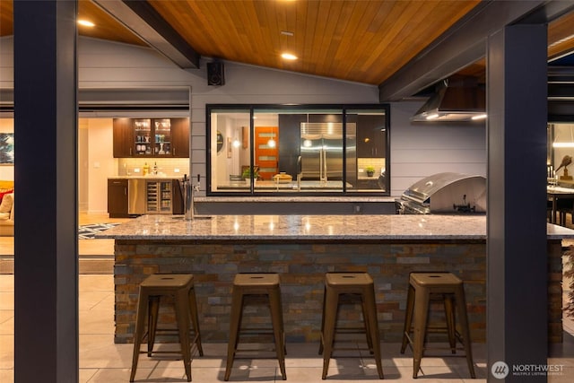 12 Columbia Ky, Bellevue, WA 98006 - indoor wet bar featuring wood ceiling, vaulted ceiling, under cabinet range hood, light tile patterned flooring, and wooden walls