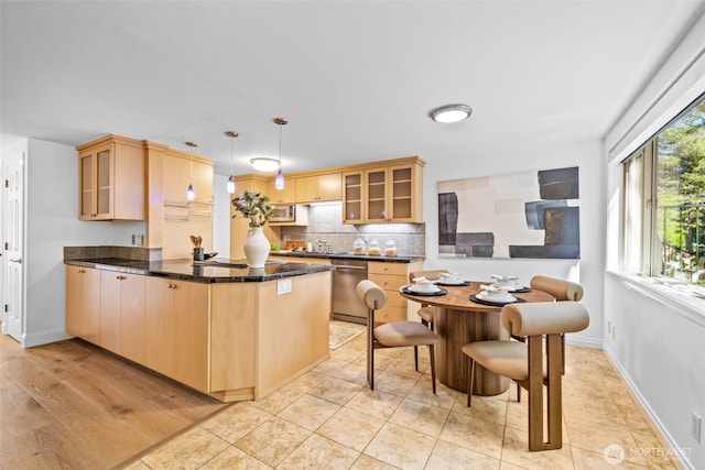 3834 175th Ave NE Unit 101, Redmond, WA 98052 - kitchen with appliances with stainless steel finishes, a peninsula, glass insert cabinets, dark countertops, and light brown cabinetry